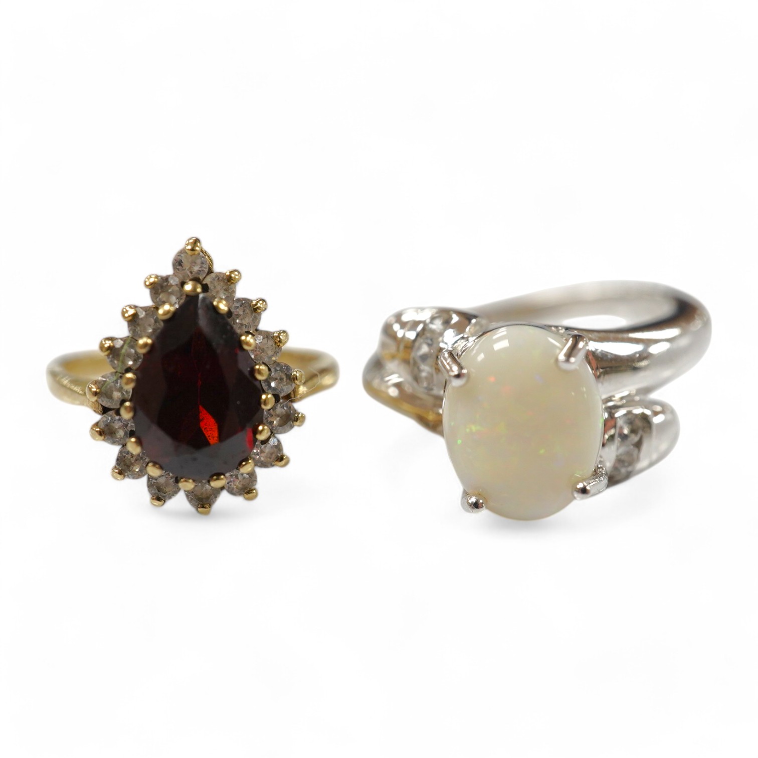 A modern 9ct white gold and single stone cabochon white opal set ring, size N and a 9ct gold, garnet and white sapphire? cluster ring, gross weight 6.7 grams. Condition - fair to good